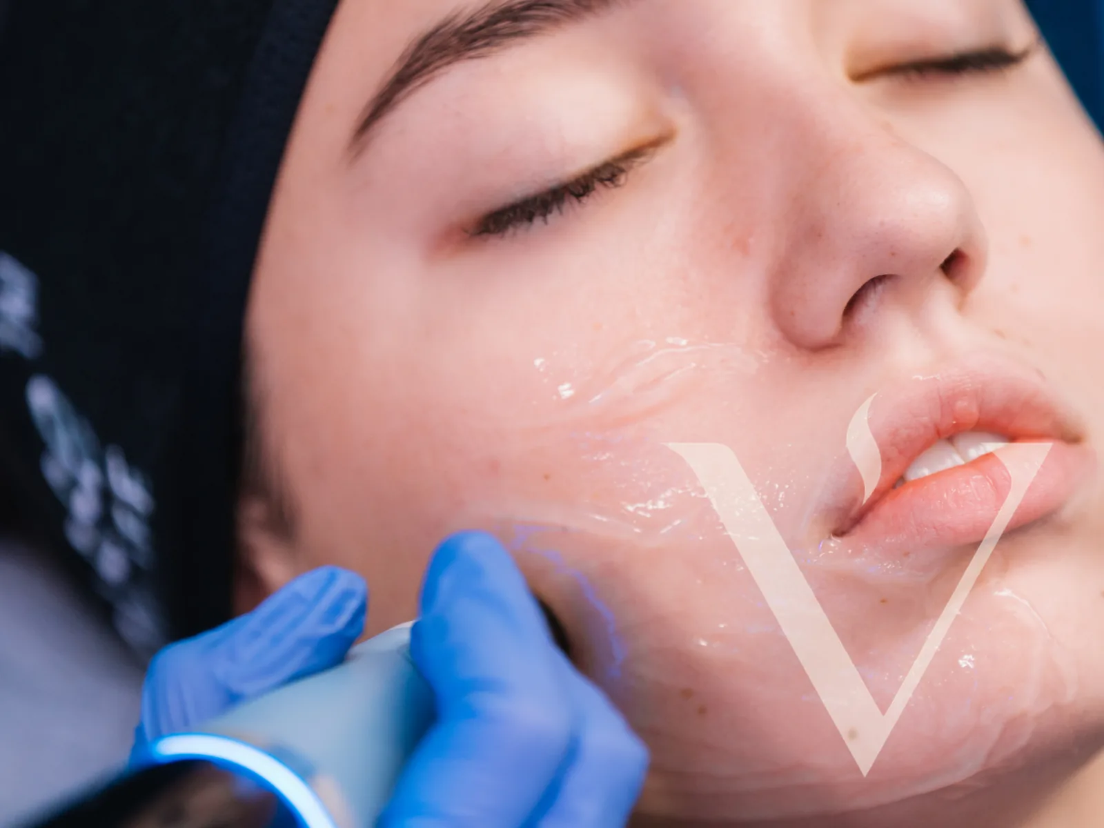 A physician treating a client's jawline with an ultrasonic facial device at CANVAS Medical Clinic, Penang