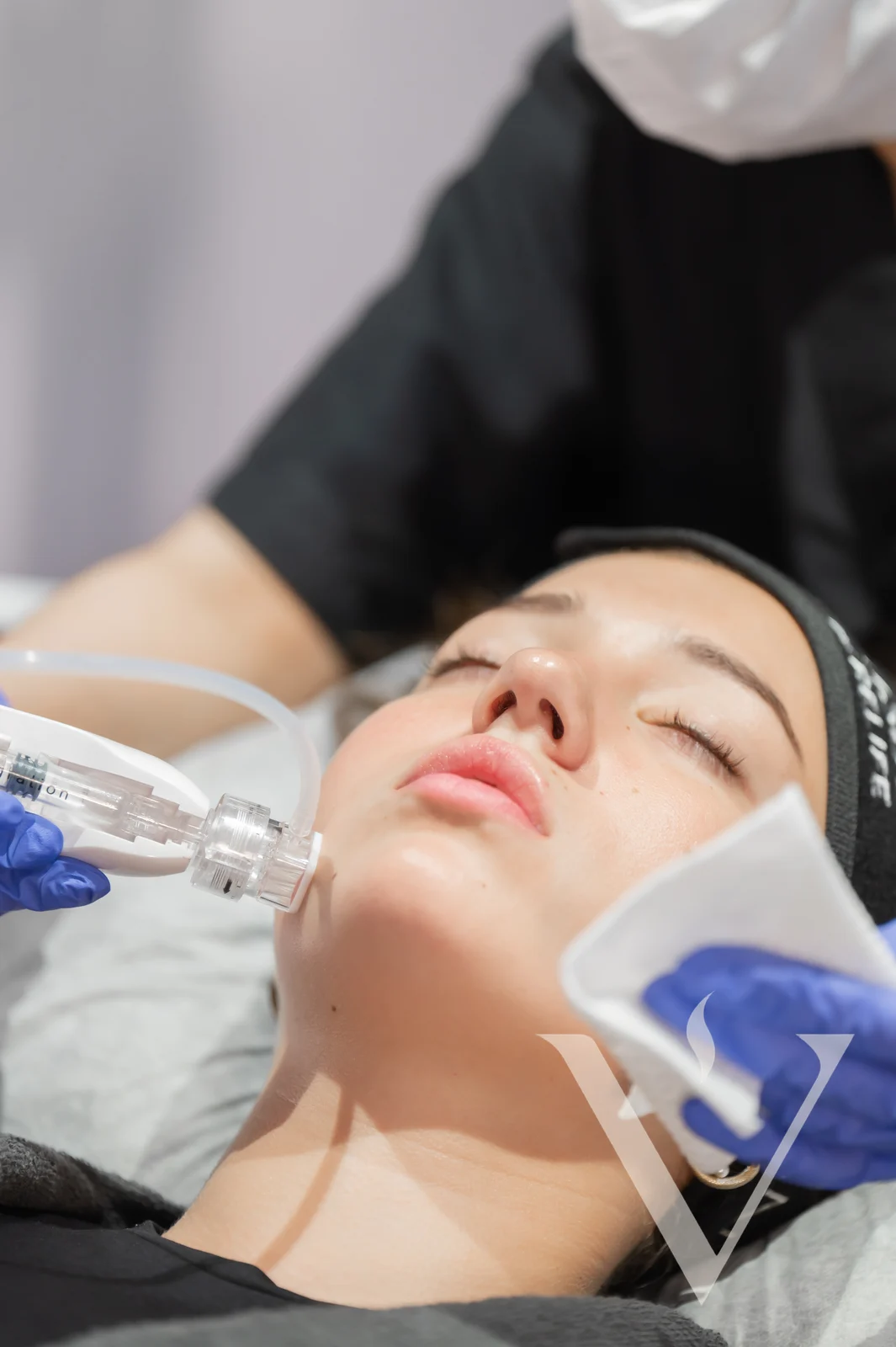 A physician performing a facial treatment at CANVAS Medical Clinic, Penang