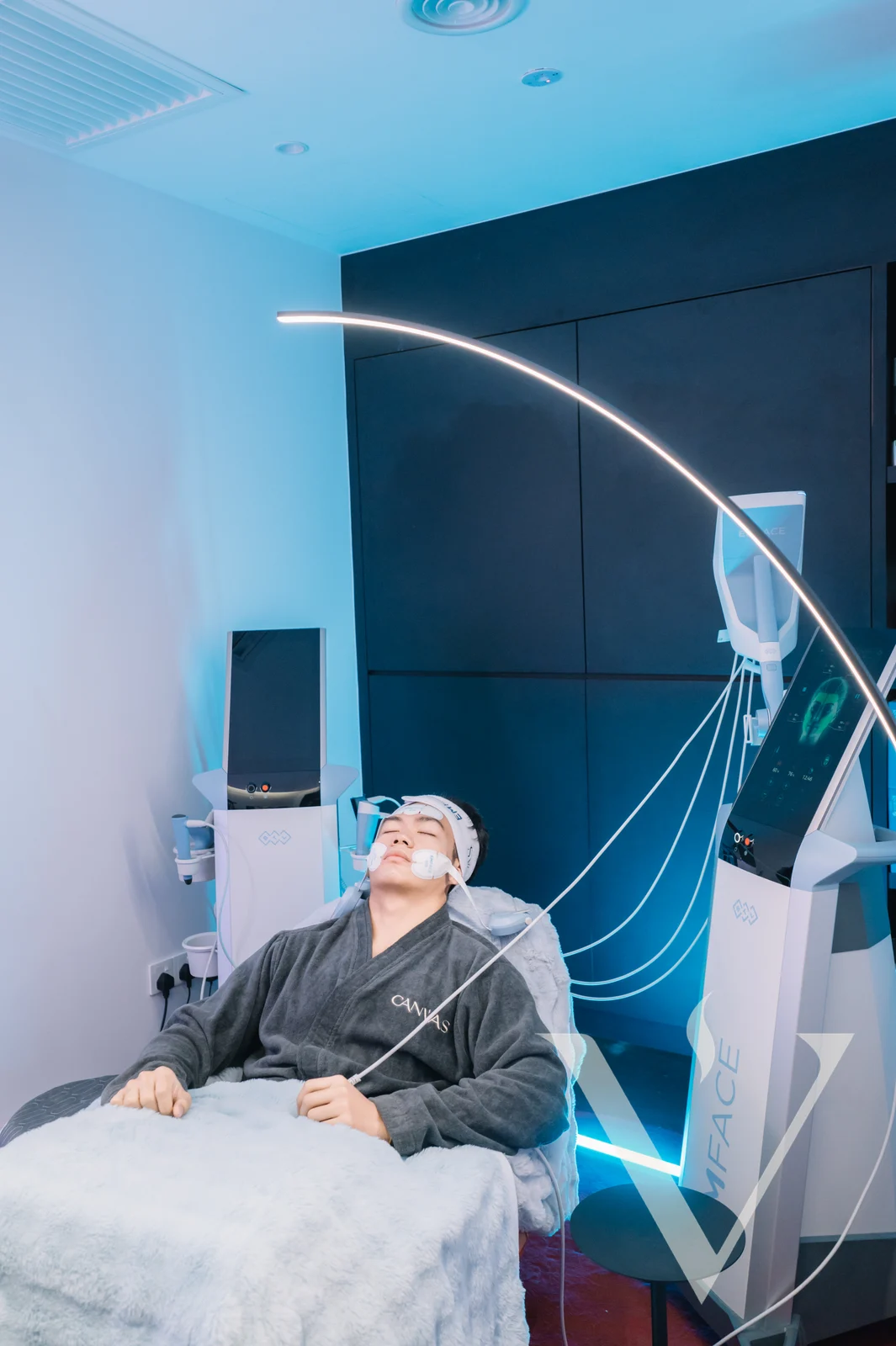 A client receiving EMFACE treatment in the treatment room at CANVAS Medical Clinic, Penang